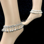 Tribe Nawaar's silver belled anklets. Great for belly dance, festivals and so much more! Image of anklets modeled.