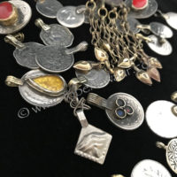 Grab bag of assorted coins & small pendants from Tribe Nawaar, detail.