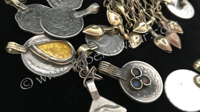 Grab bag of assorted coins & small pendants from Tribe Nawaar, detail.